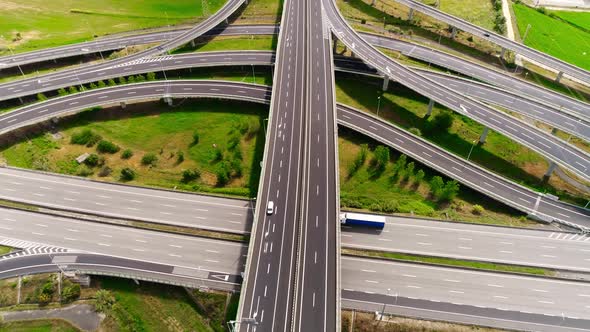 Freeway Road with Moving Cars Between Green Fields