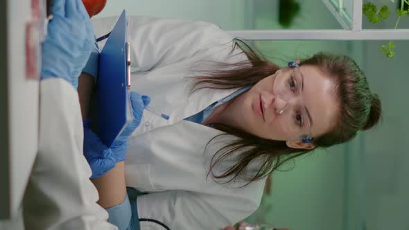 Vertical Video Two Collegues Checking Sample of Vegan Meat Writing Biotechnology Expertise