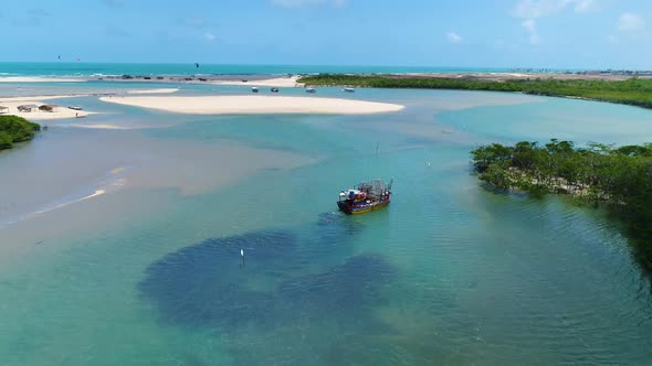 Aerial view of fishing boat navigating on transparent river, Cascalve, Brazil.