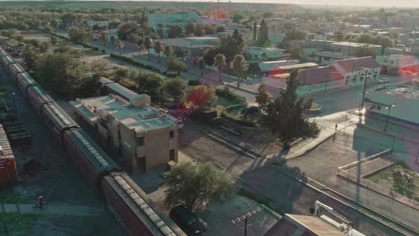 Aerial Of A Freight Train Passing Through Mexican northern Countryside