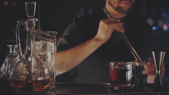 Bartender Prepares a Cocktail at the Bar