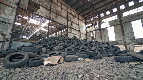 Old tires at a dump. Pile of old tires stacked in junkyard panned up from base to top