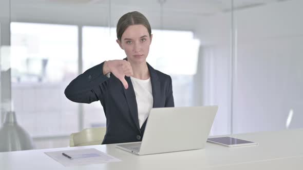 Young Businesswoman Doing Thumbs Down in Office 