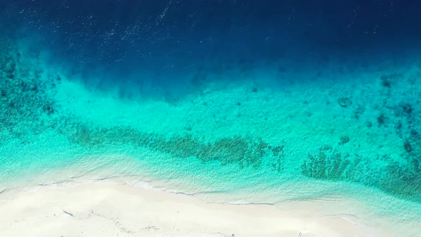 Aerial flying over seascape of luxury coast beach vacation by blue ocean with white sand background 