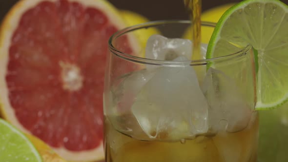 Pour Whiskey, Cognac, Liqueur From a Bottle Into a Glass Cup. Close-up