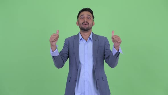 Happy Young Bearded Persian Businessman Giving Thumbs Up and Looking Excited