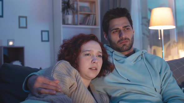 Couple Watching Horrible Scene on TV