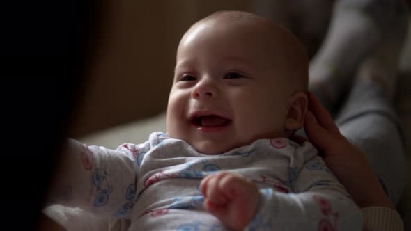 Newborn Baby With Young Mom Look Into Each Other Eye