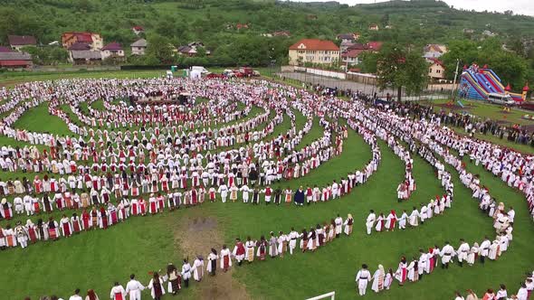 Aerial view of peasants dancing in a circle