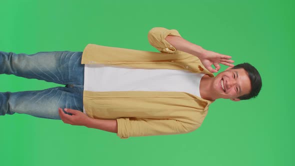 A Portrait Of A Happy Asian Man Showing Okay Gesture To The Camera In The Green Screen Studio