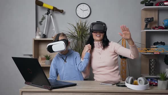  Woman Playing Video Games with Her Teen Smiling Son Using Protective Virtual 3d Glasses