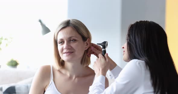 Doctor Examines Ear of Adult Woman Closeup