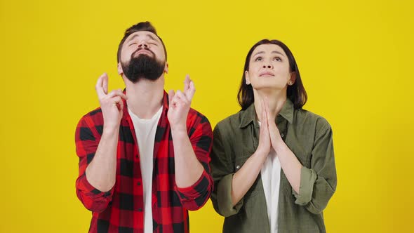 Superstitious Young Couple Crossing Fingers Wish for Good Luck Concept Funny Stressed Man and Woman