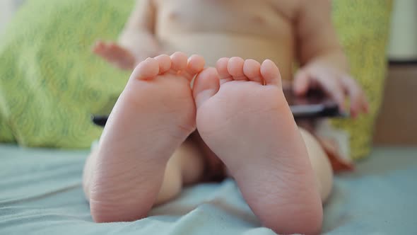 small child and modern technology. sitting child with electronic tablet