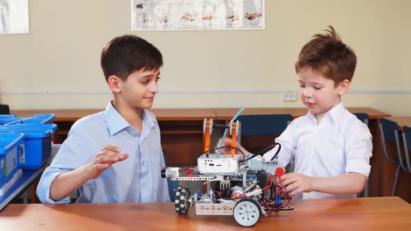 Kids Playing with Electrical Robot While Visiting Robotics Exhibition