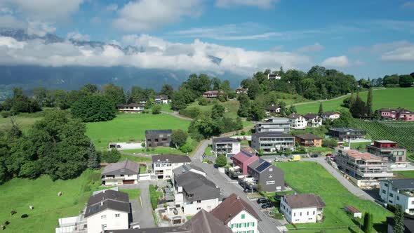 Aerial View of Liechtenstein with Houses on Green Fields in Alps Mountain Valley