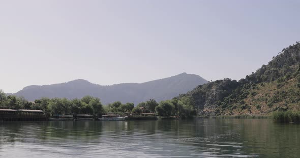 Boat cruising on a traditional boat through the stone valley on the river at Dalaman Stream