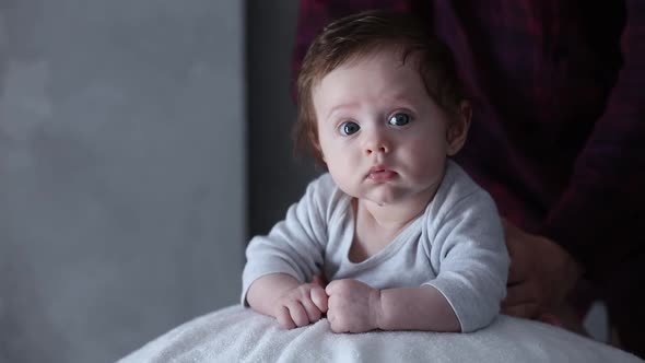 newborn boy exercises on a ball together with his parent