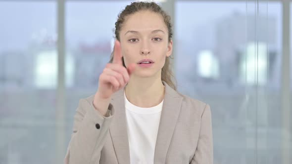 Portrait of Beautiful Young Businesswoman Pointing at Camera