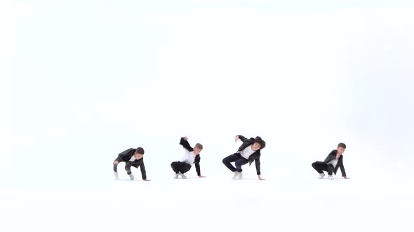 Little Boys Are Dancing a Modern Dance on the White Background in Black Leather Jackets and Jeans