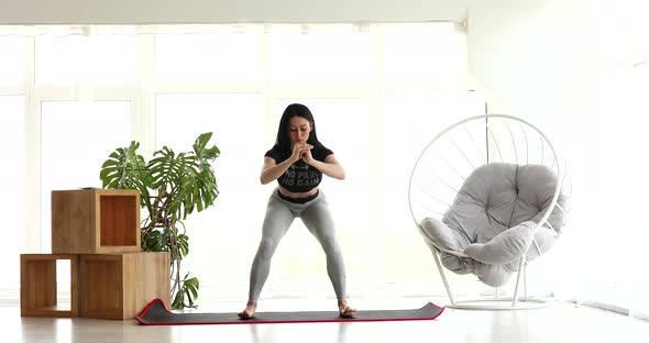 Young woman doing sports, fitness at home.