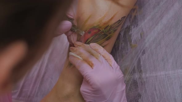 Needle Tattoo Machine Inject a White Ink Into the Skin of a Woman