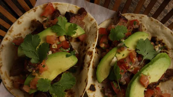 Rotating shot of delicious tacos on a wooden surface - BBQ 132