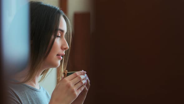 Beautiful Girl Drinking Tea or Coffee