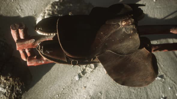 Rider Leather Saddle on Fence in Desert