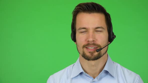 A Young Handsome Call Center Agent Talks To the Camera with a Smile - Closeup - Green Screen Studio