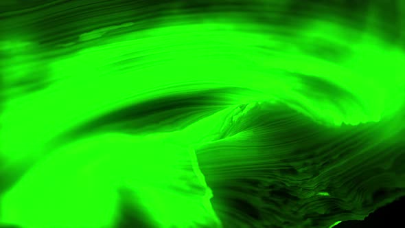Green vibrant glowing abstract shape flowing against black background
