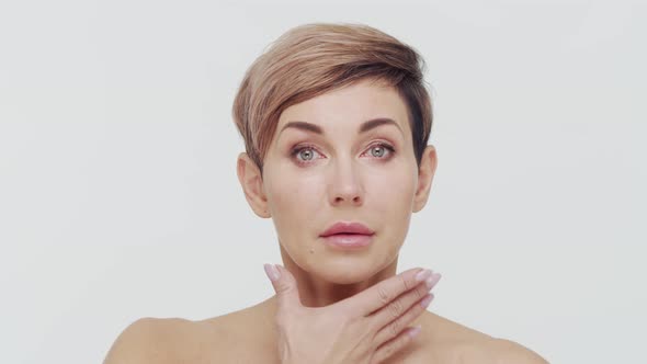 Close-up of middle aged mature woman over white background.