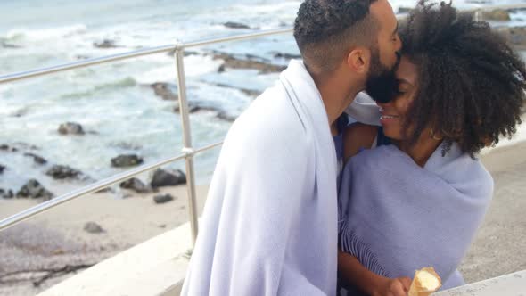 Couple having ice cream cone at beach 4k