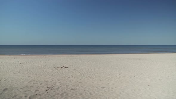 Side Walking on Smiltyne Beach on a Calm And Sunny Day