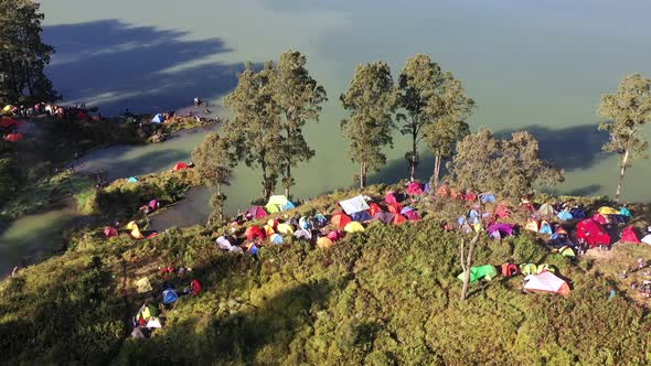 Campsite near the crater lake of Mount Rinjani Volcano in Indonesia, Nusa Tenggara, Aerial orbit aro