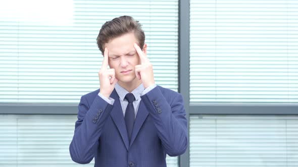 Headache Gesture by Young Businessman