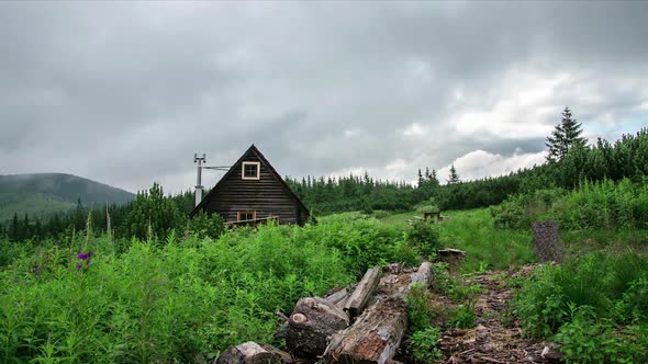 Grey Clouds Moving over Small Mountains Hut in Green Wilderness Nature