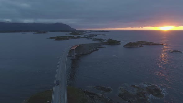 Atlantic Ocean Road in Norway and Cars at Summer Sunset