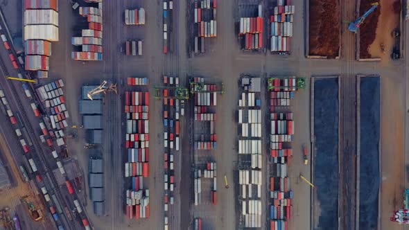 Bird's Eye View of the Port Cargo Area with Containers Bulk Cargo Cranes Trucks and Forklifts