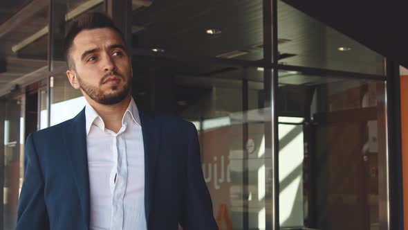 Elegant businessman in airport. Young mail entrepreneur in formalwear.