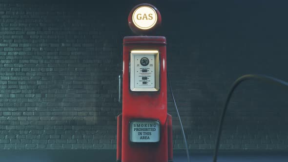 Retro gas pump. The old, rusted, red device is working and pumping gasoline.