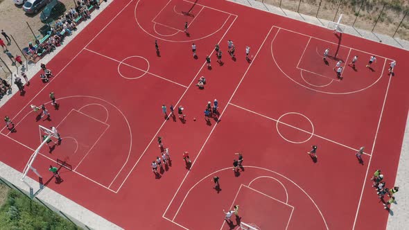 Aerial View of Young Athletes Playing Basketball on an Outdoor Public Basketball Court