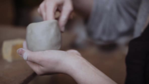 Close-up of female potter working with clay