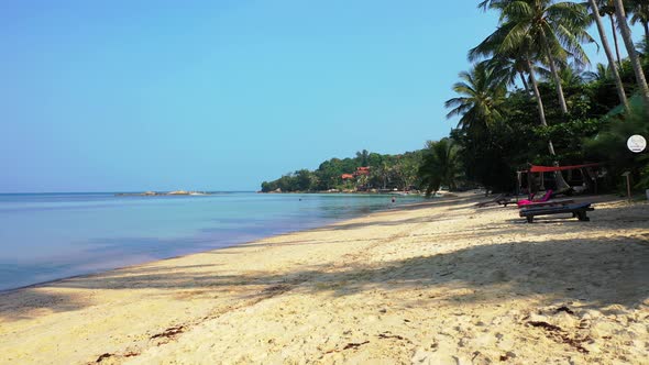 Natural fly over travel shot of a paradise sunny white sand beach and blue water background in best 