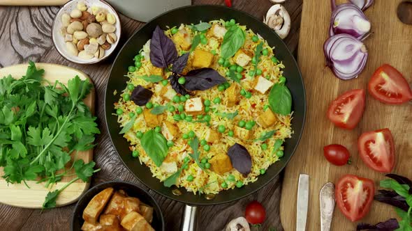 Vegetable Rice with Green Peas Carrots Tofu and Mushrooms on Wooden Background