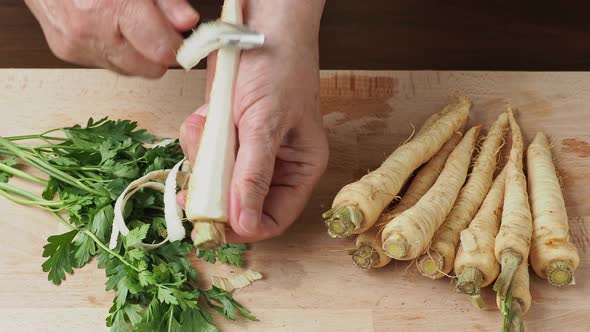 Hands peeling parsley in the kitchen