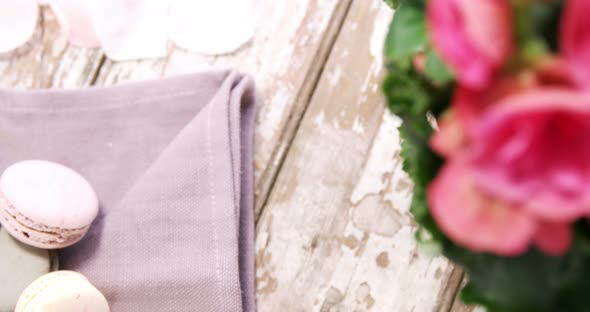 Macaroons and pot plant with pink flowers