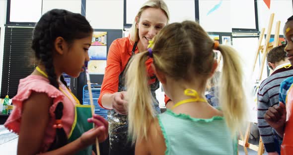 Teacher interacting with students in drawing class