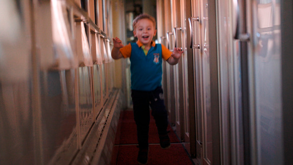 Boy Running In The Train And Looking 