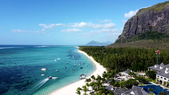 Aerial: Flight along paradise island with palm tree anding boat,mauritius